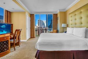 a hotel room with a large bed and a television at MGM 1BR Suite 7th Floor Strip View, Balcony in Las Vegas +26 photos