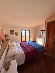 a bedroom with a large bed and a window at Zanella House in Quartu SantʼElena
