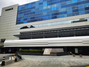 a large office building with a lot of windows at Yeoksam Molta 1 in Seoul