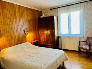 En eller flere senge i et værelse på Maison de Famille Vintage Cosy