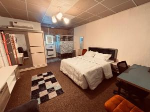 a bedroom with a bed and a mirror in it at DeadSea studio in Sowayma