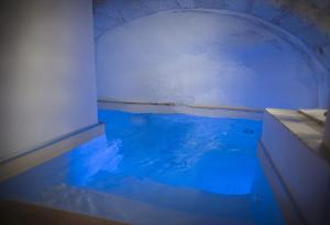 a pool of water in a room with blue light at ViaGiusti 51 in Ostuni