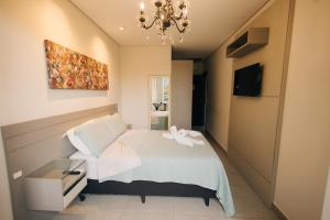 Et tv og/eller underholdning på Jardim do Rio Suítes