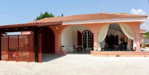a small house with a patio and a fence at Bed & Breakfast Villa Corallo Parcheggio privato in Porto Cesareo +18 photos