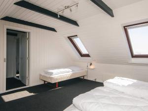 a attic room with two beds and a window at 5 person holiday home in Snedsted in Snedsted