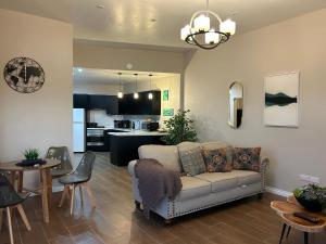 a living room with a couch and a kitchen at Serene Sunset Escape - Panoramic Ocean View Apartment in Castries