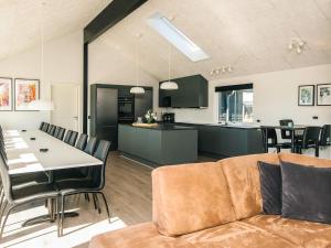 a living room and kitchen with a couch and a table at Luxury Retreat with Pool - By Traum Ferienwohnungen in Harboør