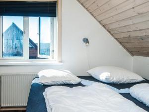 two beds in a room with a window at 12 person holiday home in Thyborøn-By Traum in Thyborøn +48 photos