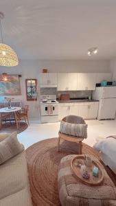 a living room with a couch and a table and a kitchen at Cozy Coach House in Kitchener