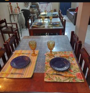 a table with plates and glasses on top at Pousada Casa do Peregrino in Pesqueira +4 photos
