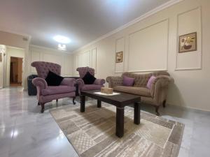 a living room with couches and a coffee table at Comfortable 3BR New Cairo Prime Spot in Cairo
