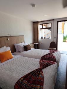 Postel nebo postele na pokoji v ubytování Casona Tobar Hotel