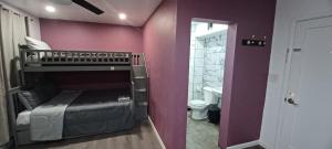 a bedroom with a bunk bed and a bathroom at ThomasRose in Phoenix