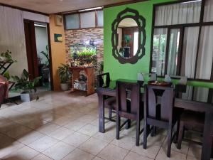 a dining room with a table and chairs and a mirror at Casa Maranta in San Miguel