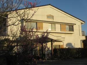 a white house with a tree in front of it at Ogawaya Ryokan - Vacation STAY 15998v in Tahara +4 photos