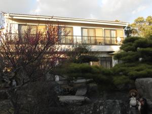 a building with a garden in front of it at Ogawaya Ryokan - Vacation STAY 15998v in Tahara