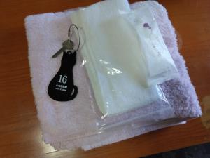 a white cake in a plastic container with a key at Ogawaya Ryokan - Vacation STAY 15998v in Tahara