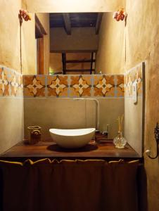 a bathroom with a bowl sink and a mirror at Los Amarantos in Tilcara