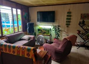 a living room with a couch and a fish tank at Casa Maranta in San Miguel