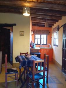 a kitchen with a table and chairs in a room at Los Amarantos in Tilcara +32 photos