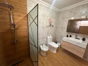 a bathroom with a toilet and a sink at Villa Amarilis in Boca Chica