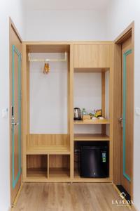 a cabinet with a tv inside of it at La Playa Ha Long Hotel in Ha Long