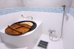 a bathroom with a toilet with a wooden seat at 古民家の宿 奈味 in Saitama +19 photos