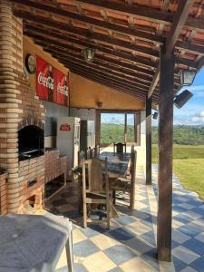 a patio with a table and a fireplace at Sítio frente à Barragem in Salesópolis