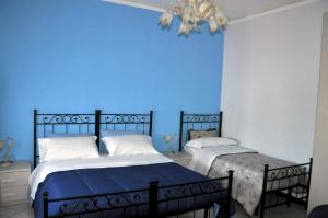 מיטה או מיטות בחדר ב-B&B Villa Angelica