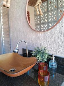 a bathroom sink with a faucet and a mirror at Aeroporto 2 Quartos Self-chek in in Recife +38 photos