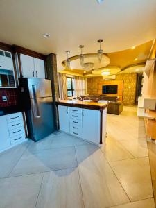 a kitchen with a refrigerator and a sink in it at Apartamento Duplex Rio grande centro 250 m privado dois quartos in Rio Grande +5 photos