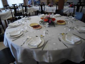 a table with plates of food and wine glasses at Domus Viatoris in Sahagún