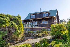 a house on a hill with bushes at Ocean Views 20kms from CBD Sleeps 10 in Kingston Beach