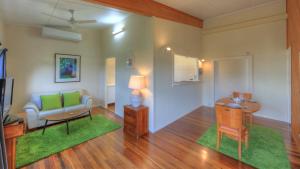 a living room with a couch and a table at Village Stays Bungalow and Apartment in Ulmarra