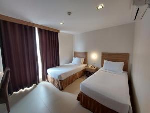 Postel nebo postele na pokoji v ubytování Mango Suites