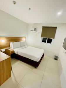 Postel nebo postele na pokoji v ubytování Mango Suites