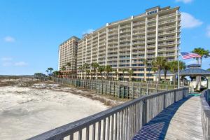 a large hotel on the beach next to the ocean at Doral 103 - Charming Beachfront / Ground Floor Condo! in Gulf Shores