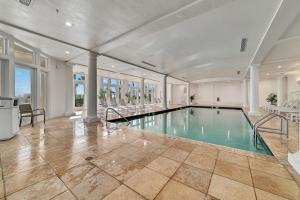 an indoor swimming pool in a large room with columns at Doral 103 - Charming Beachfront / Ground Floor Condo! in Gulf Shores +51 photos