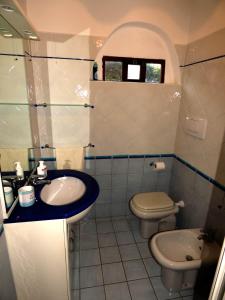 a bathroom with a sink and a toilet at Villa Vista in Stintino