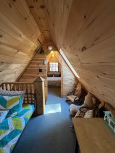 a cabin with a loft with a bed and a table at Bearly Behavin in Blue Ridge