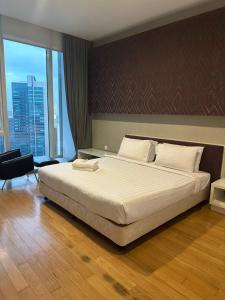 Ένα ή περισσότερα κρεβάτια σε δωμάτιο στο KLCC Suites at Platinum +155 φωτογραφίες