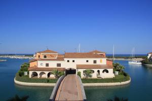 a large house on a island in the water at Marinagri Resort in Policoro