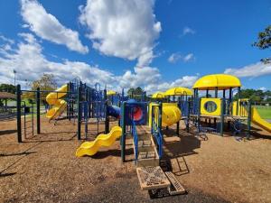 a playground with a slide and a play structure at Charming 1-Bedroom Condo at Raffles in North Ocean City, Steps from Northside Park in Ocean City