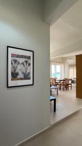 una sala de estar con una foto en la pared en Lily of Crete 1 - Sea & Beach front Apartment, en Kalamaki