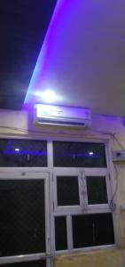 a ceiling with purple lights on top of a door at श्री कृष्णा होम स्टे in Vrindāvan