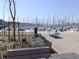 a couple of benches in a marina with boats at Charmant apt famille avec balcon au Port du Crouesty, parking inclus - FR-1-639-55 in Arzon +5 photos
