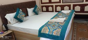 a bed with towels and pillows on it at Unnati Residency in Varanasi
