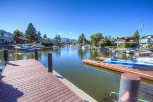a dock with boats in a marina with houses at TKH1226 - Emerald Lodge in South Lake Tahoe