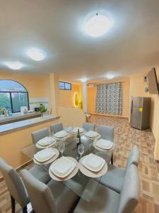 a dining room with a table and chairs and a kitchen at Family Apartment in San Cristóbal with 2 Bedrooms, 4 Beds, Living Room, Dining Area, Kitchen, Satellite WiFi and 1 Bathroom with Hot Water - CoralBay - Galápagos Home in Puerto Baquerizo Moreno +65 photos