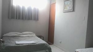 a small bedroom with a bed and a window at Casa El Valle de Lunahuaná in Lunahuaná